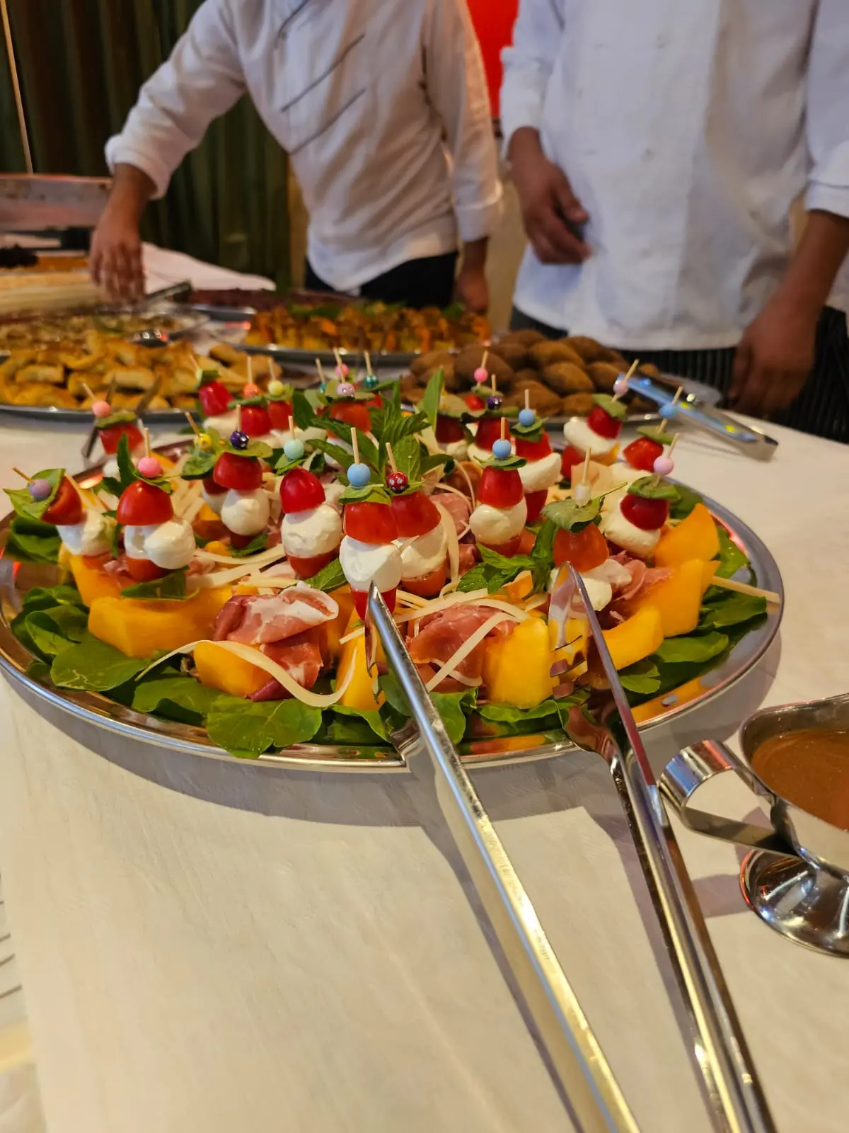 Chef arranging colorful canapés for an event