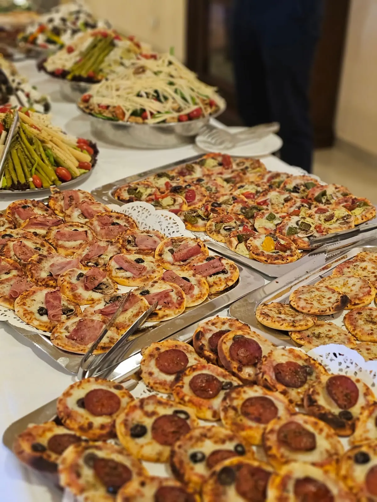 Trays of assorted pizzas prepared for an event