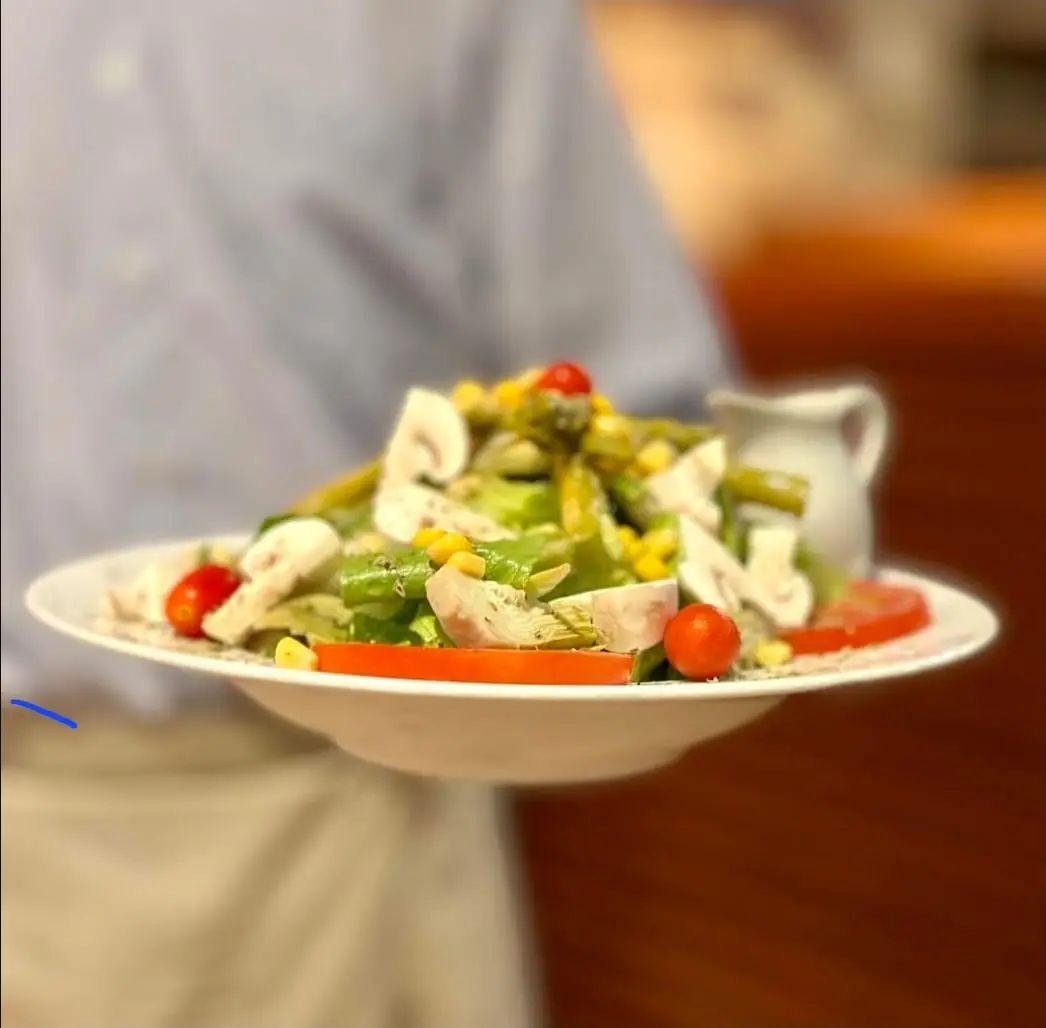 Fresh green salad with mushrooms, corn and cherry tomatoes